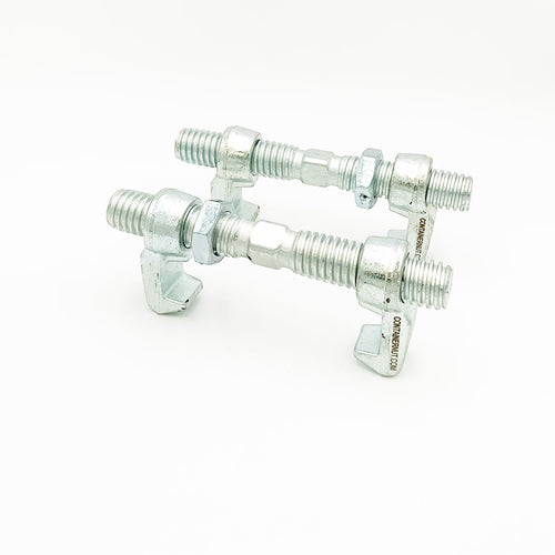 Two silver Bridge Fittings by Container Nut are positioned on a white surface. The fittings have a shiny finish and feature threaded parts with attached nuts, washers, and hinged clamp pieces designed for fastening.