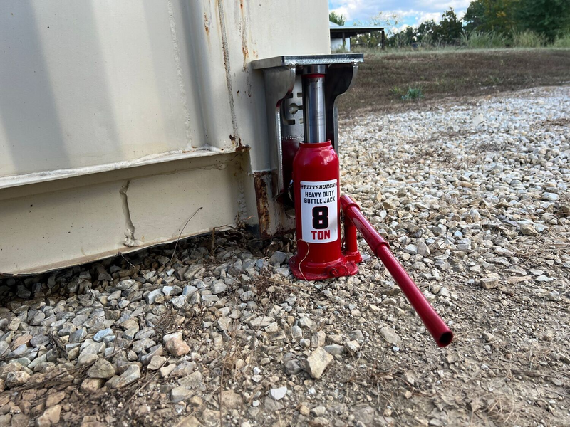 Load image into Gallery viewer, EZY Lift in use leveling a shipping container with a red bottle jack (bottle jack not included).
