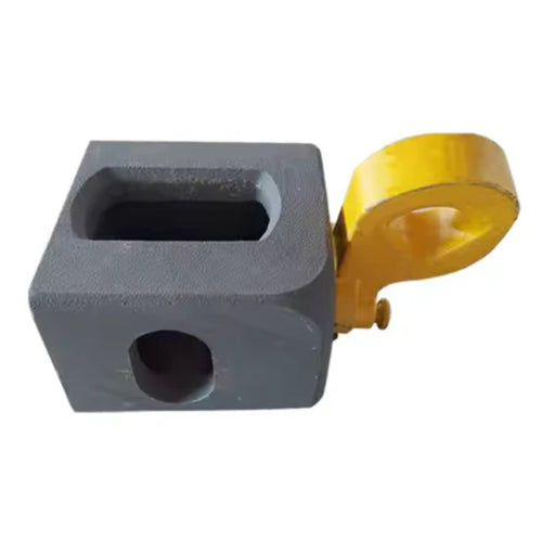 A Bottom Lifting Lug from Container Nut. A ISO corner casting has a smooth, rounded yellow hook attached to one corner. The corner casting includes a rectangular hole on the top side and a circular hole on the front side. The hook is designed to pivot from the corner, indicating its mechanical purpose.