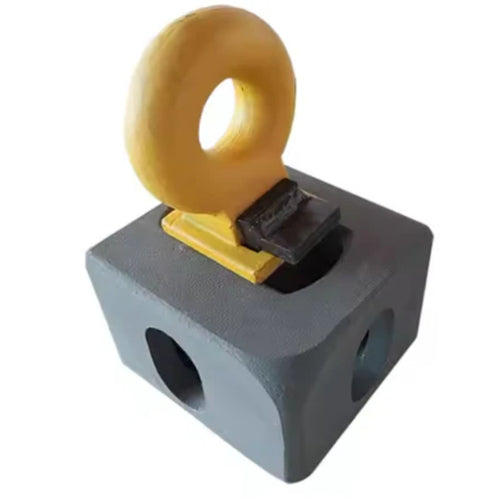 A Top Lifting Lug from the Container Nut brand is showcased in an image with a white background, featuring its geometric and industrial design. The yellow, circular ring structure is mounted on top of a gray, cube-shaped object with circular holes on three sides, all connected by a small black platform.