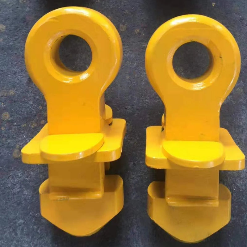 Load image into Gallery viewer, Two yellow Top Lifting Lugs from the brand Container Nut, featuring rounded tops and circular holes in the center, are arranged in one neat row on a dark, textured surface.
