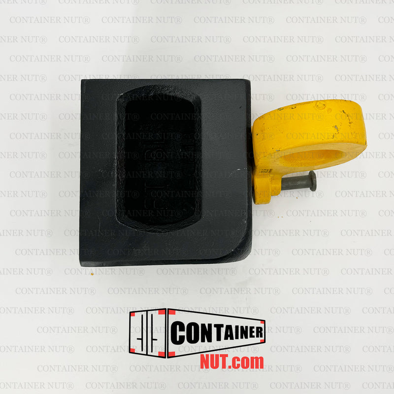 Load image into Gallery viewer, A Bottom Lifting Lug from Container Nut. A ISO corner casting has a smooth, rounded yellow hook attached to one corner. The corner casting includes a rectangular hole on the top side and a circular hole on the front side. The hook is designed to pivot from the corner, indicating its mechanical purpose.
