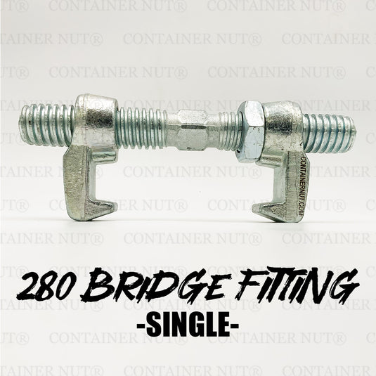 A silver Bridge Fitting from the Container Nut brand, featuring two hooked ends against a plain gray background. It includes threaded rods extending from both ends, connected by a central barrel that can be rotated to adjust the tension. The surface is shiny and galvanized.