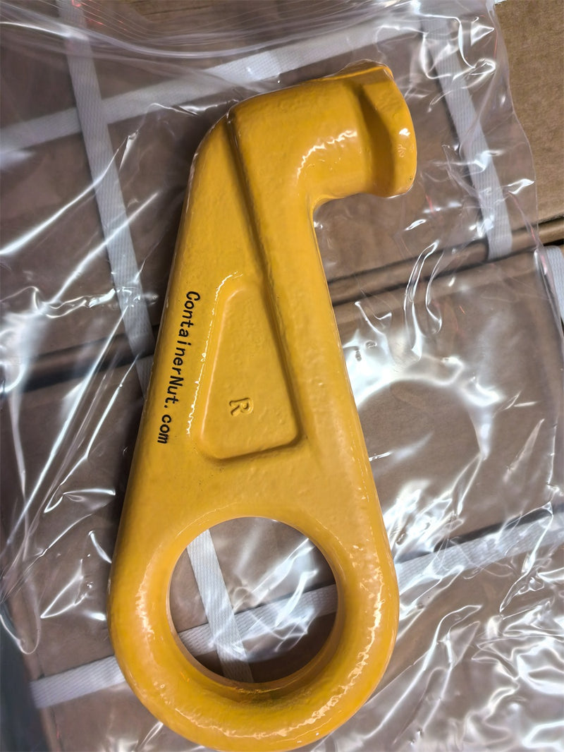 Load image into Gallery viewer, A close-up photo of a yellow metal tool, identified as the Right/Left Hook from Container Nut, featuring a large circular opening at one end and an angled, notched extension at the other. The tool is placed inside a clear plastic bag with part of the text &quot;containernut.com&quot; visible on its side.
