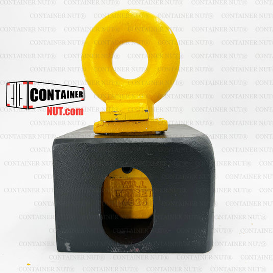 A Top Lifting Lug from the Container Nut brand is showcased in an image with a white background, featuring its geometric and industrial design. The yellow, circular ring structure is mounted on top of a gray, cube-shaped object with circular holes on three sides, all connected by a small black platform.