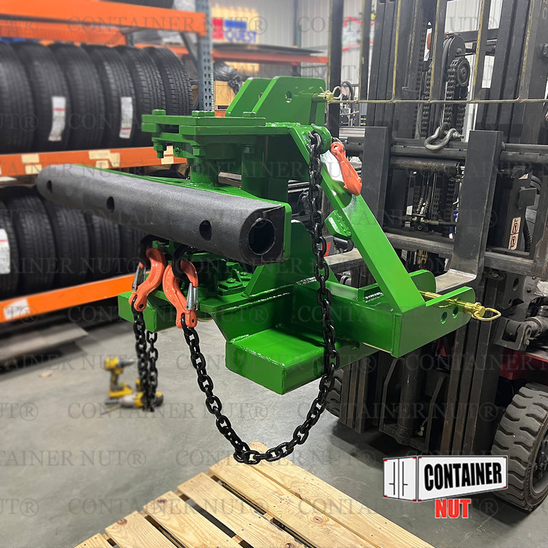 Load image into Gallery viewer, An EZY Hitch, branded by Container Nut, featuring various mechanical components, chains, and hooks in green is connected to a forklift in a shop. Logos and text reading &quot;CONTAINER NUT&quot; are partially visible on the bottom right.
