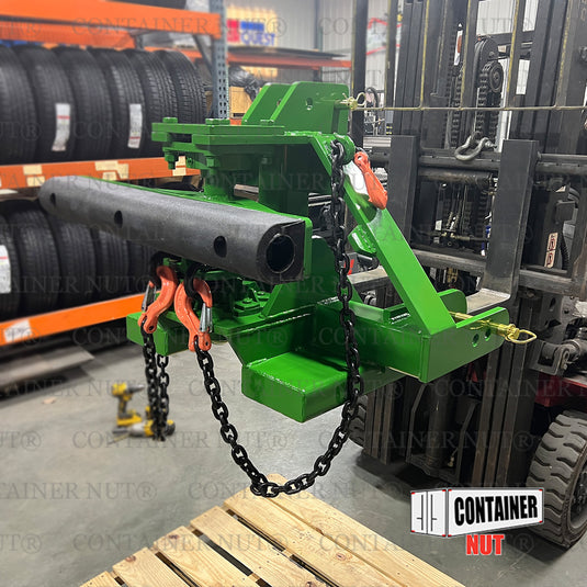 An EZY Hitch, branded by Container Nut, featuring various mechanical components, chains, and hooks in green is connected to a forklift in a shop. Logos and text reading "CONTAINER NUT" are partially visible on the bottom right.