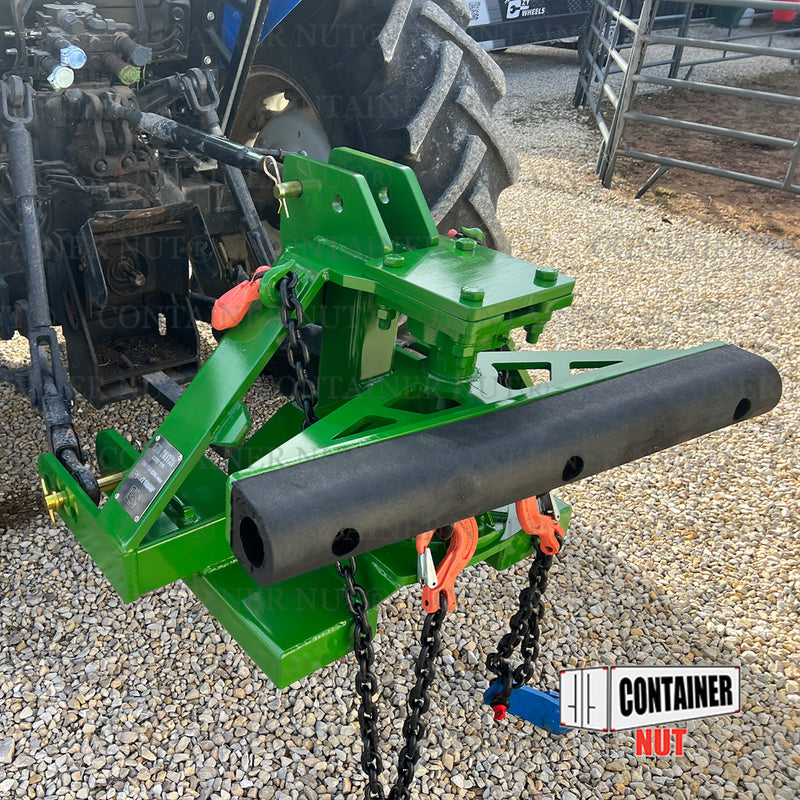 Load image into Gallery viewer, An EZY Hitch, branded by Container Nut, featuring various mechanical components, chains, and hooks in green is connected to a black tractor. The setup is situated outdoors on a gravel surface. Logos and text reading &quot;CONTAINER NUT&quot; are partially visible on the image.
