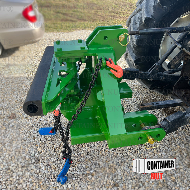 Load image into Gallery viewer, An EZY Hitch, branded by Container Nut, featuring various mechanical components, chains, and hooks in green is connected to a black tractor. The setup is situated outdoors on a gravel surface. Logos and text reading &quot;CONTAINER NUT&quot; are partially visible on the image.
