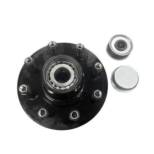 A Container Nut Trailer Idler Hub, featuring a black finish and six bolts, is placed on a white background. Next to it, on the right side, are two metallic hub covers, with one showing a visible inner part.